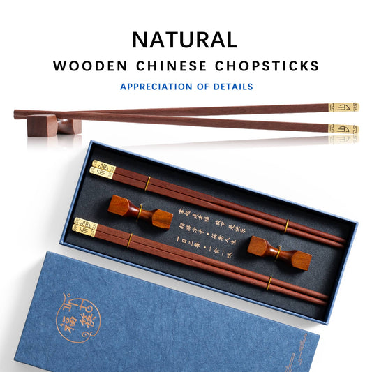 Two pairs of natural wood Chinese chopsticks and a wooden chopstick holder in the shape of a dumbbell in a gift box.