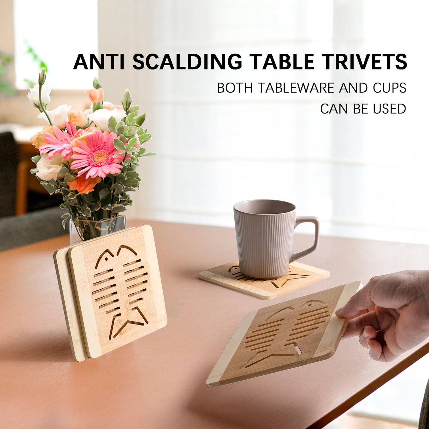 On the tabletop are four natural bamboo fish-shaped pot holders with coffee mugs on top of the mats