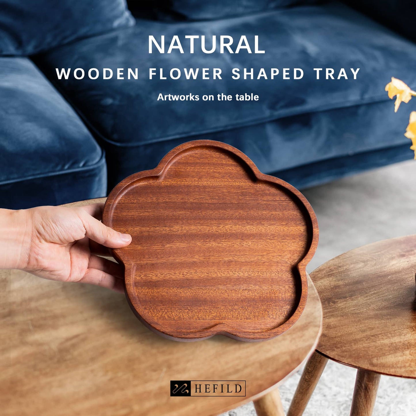 A man holds this natural wooden plate in the shape of a peach blossom made of pure natural wood