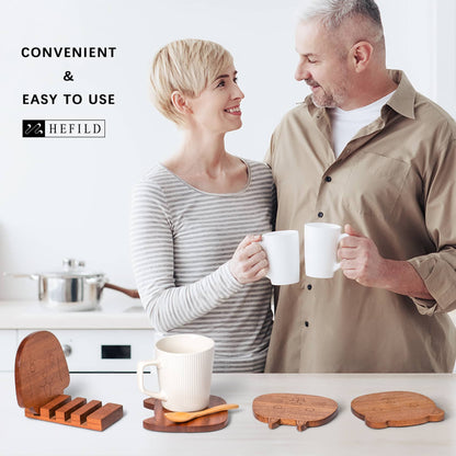 A couple happily sipping tea with animal wood coasters on the table. A great textured wooden coaster stuck on a wooden holder